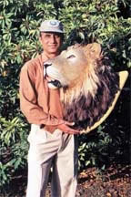 Suresh Pandit (wildlife artist) holding Asiatic Lion Head trophy..